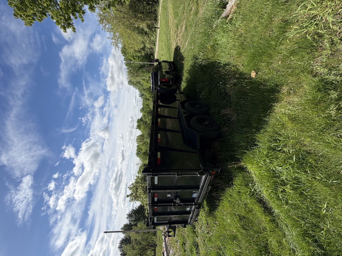 Haul-It Heroes dump trailer staged at a cleanup property