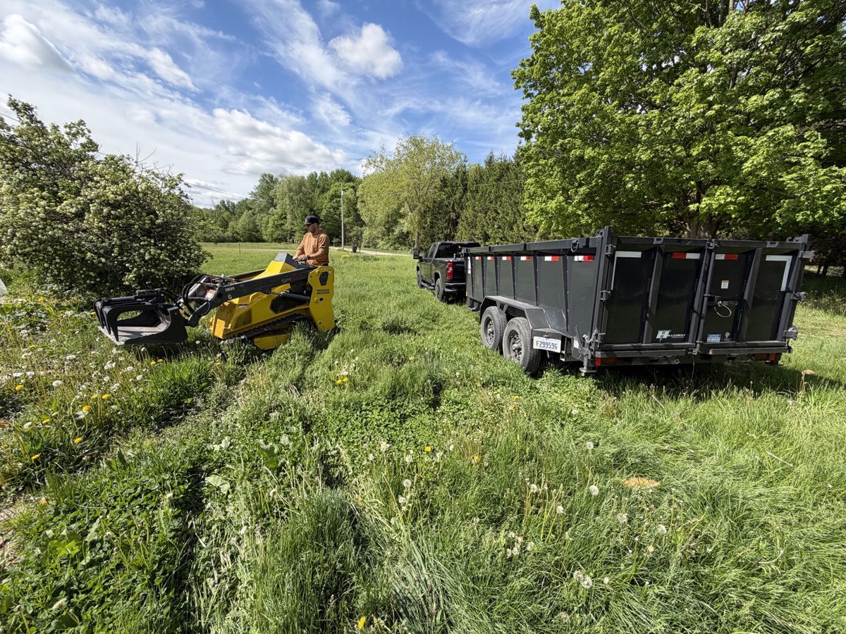 Haul-It Heroes trailer and equipment ready for a cleanup job