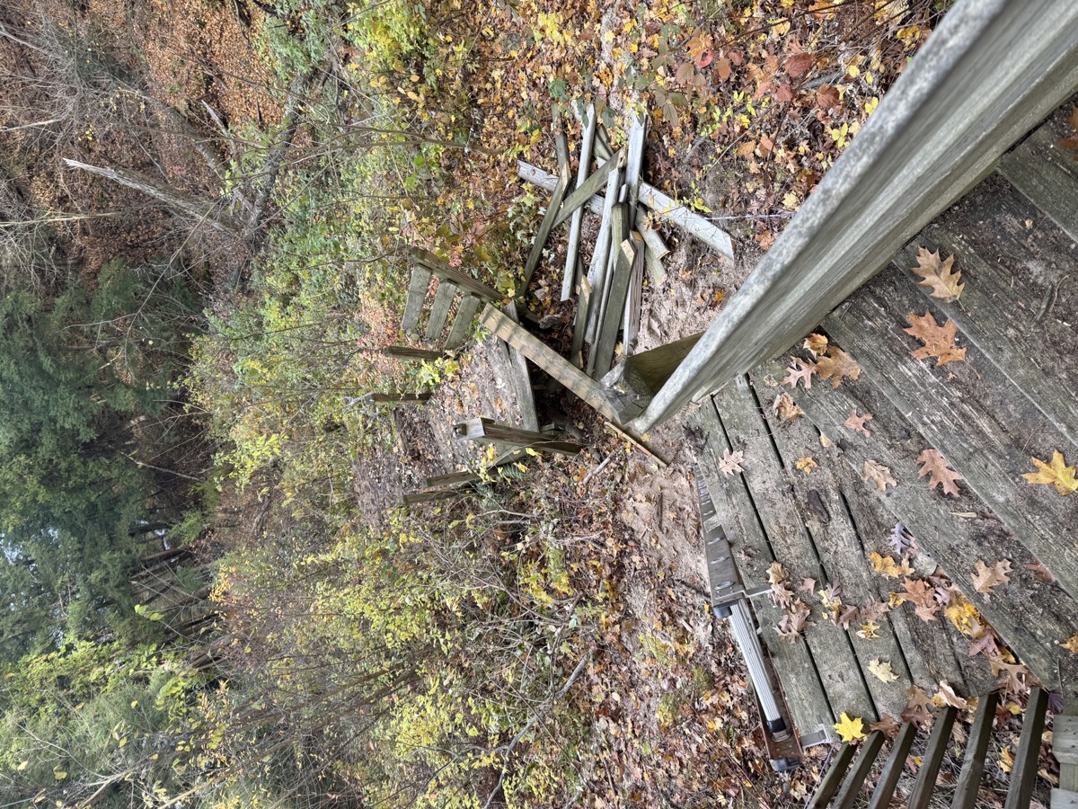 Damaged wood railing and debris ready for removal