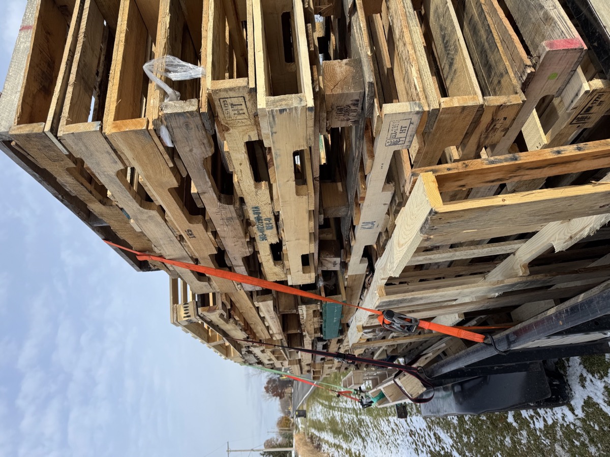 Stacked pallets secured on a trailer for hauling